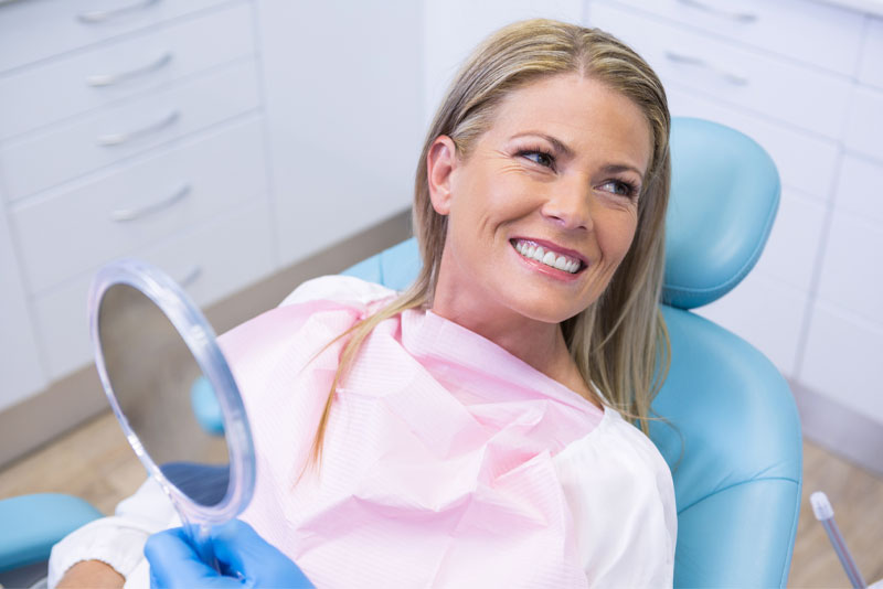 An image of a woman at a dental office.