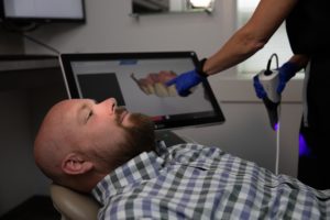 a dental patient in bloomfield hills, MI being scanned to decide on full mouth dental implant options.