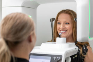 a dental implant patient receiving a scan before an implant procedure.