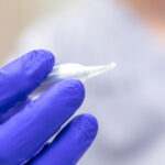 a dental professional holding a dental lasery for soft tissue treatment.