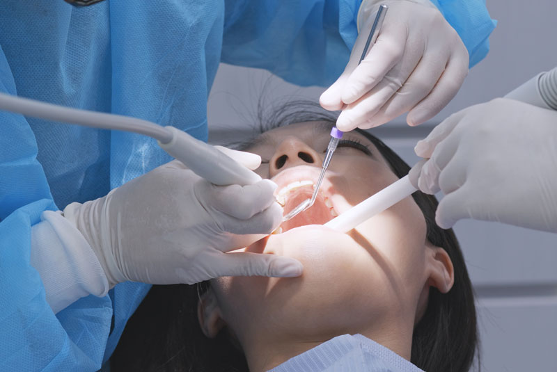 a dental patient undergoing a scaling and root planing procedure to treat her gum disease.