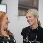 Dr. Anderson smiling with a patient after her gum disease treatment.