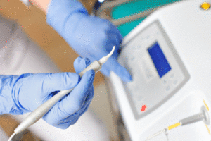 female doctor holding a dental laser