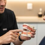 Periodontist consulting with a patient about gum grafts in a dental office.